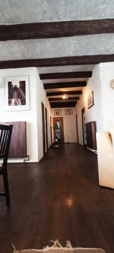 a large room with a wooden floor in a building at Bellevue Beam House in Covasna
