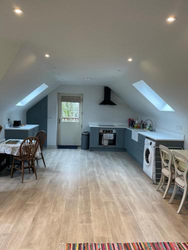 a kitchen and dining room with a table and chairs at Pettits Barn in Marlborough