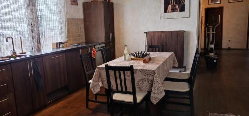 a kitchen with a table with chairs and a tableablish at Bellevue Beam House in Covasna