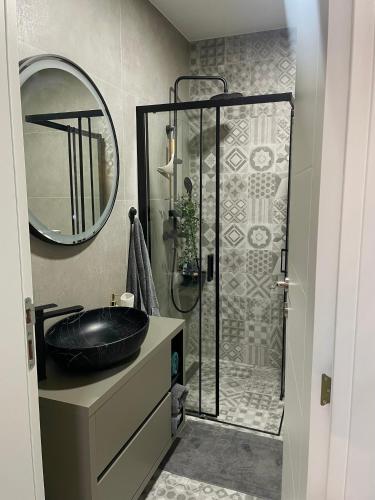 a bathroom with a black sink and a shower at Studio in Modriča