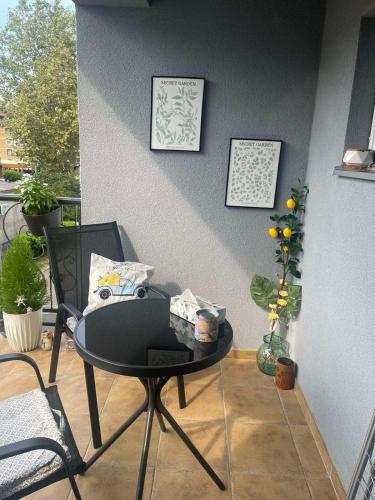 a black table and chairs on a balcony at Studio in Modriča
