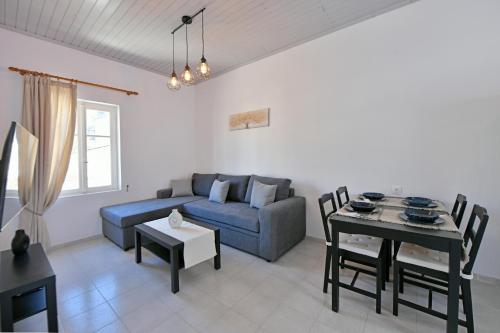 a living room with a couch and a table at Aori Guest House II in Hydra