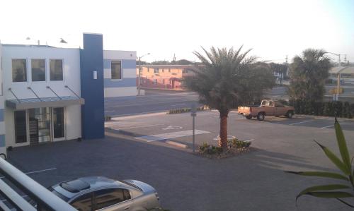 a car parked in a parking lot next to a building at Lotus Boutique Inn and Suites in Ormond Beach