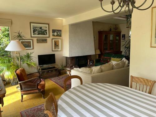 a living room with a couch and a fireplace at Maison aux camélias in Locquénolé