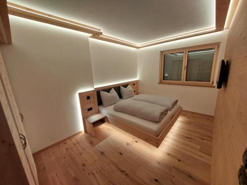 a small bedroom with a bed and a window at Dolomiten Home in Villnoss