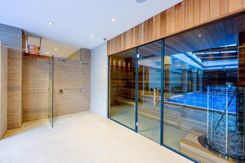 a glass house with a swimming pool at Predela 2 Aparthotel in Bansko
