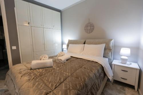a bedroom with a large bed with white pillows at Vicky 's Luxury House in Nafpaktos