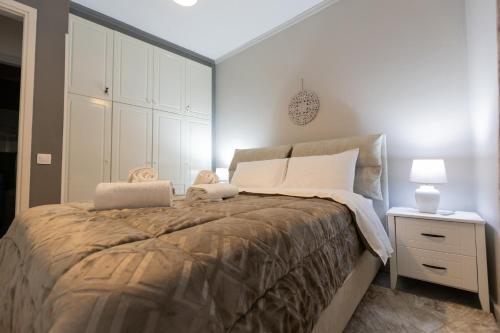 a bedroom with a large bed and a white cabinet at Vicky 's Luxury House in Nafpaktos