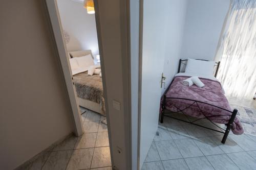 a small bedroom with a bed in a room at Vicky 's Luxury House in Nafpaktos