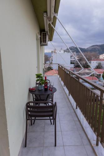 a table and chairs on a balcony with a view at Vicky 's Luxury House in Nafpaktos