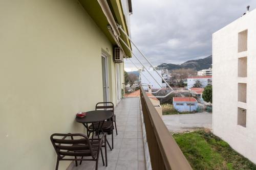 a balcony with chairs and a table on the side of a building at Vicky 's Luxury House in Nafpaktos