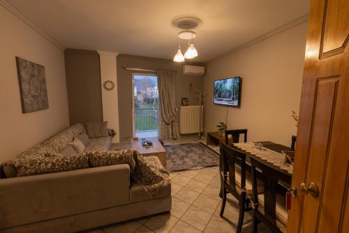 a living room with a couch and a table at Vicky 's Luxury House in Nafpaktos