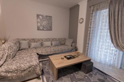 a living room with a couch and a coffee table at Vicky 's Luxury House in Nafpaktos