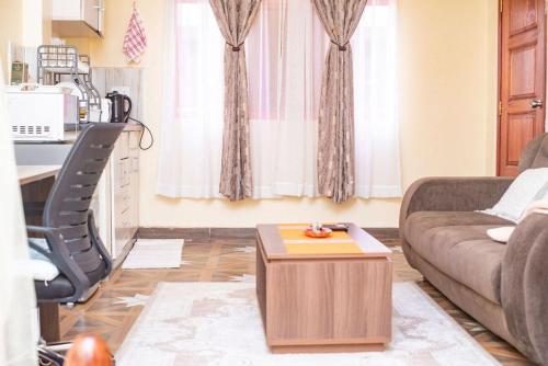 a living room with a couch and a table at Serene STUDIO apartment in Machakos in Machakos