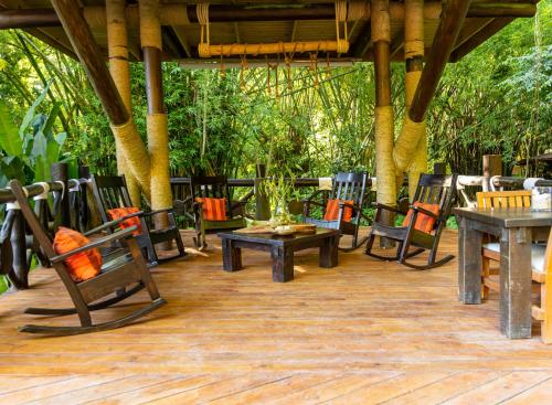 a group of tables and chairs on a patio at Platon Ecolodge in Santa Cruz de Barahona