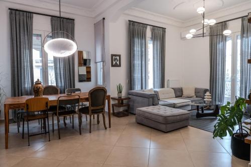 a living room with a dining table and a couch at Culturalles 2Bd APT in Thessaloniki
