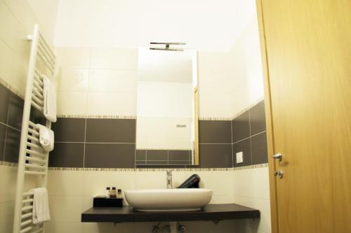 a bathroom with a sink and a mirror at B&B Silvia in Verona