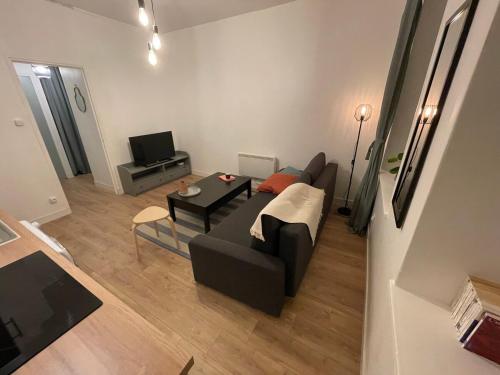 a living room with a couch and a table at Marine 1 in Cherbourg en Cotentin