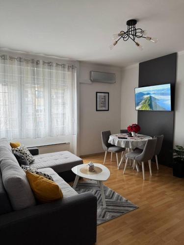 a living room with a couch and a table at Manila Apartment in Belgrade