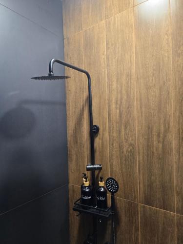a bathroom with a shower with a light on the wall at Chopan Resort Aparan in Aparan