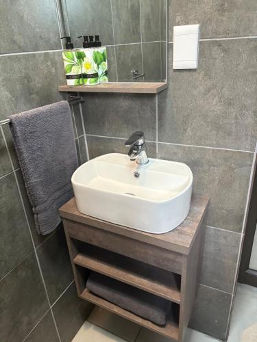 a bathroom with a sink and a mirror at Serenity Luxury Guesthouse in Krugersdorp