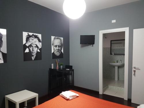 a room with a bathroom with pictures on the wall at B&B Colors in Sellia Marina