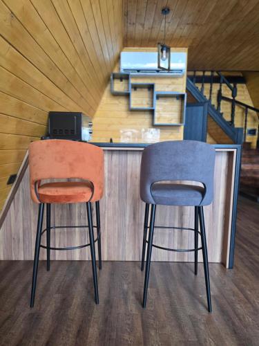 two chairs sitting in front of a counter with a laptop at Chopan Resort Aparan in Aparan