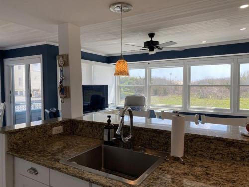 a kitchen with a sink and a counter top at 2 Bedroom 2 Bath Ocean Front Condo With Pool In Ship Bottom First Floor Unit in Ship Bottom