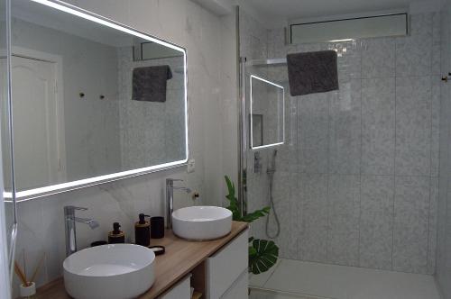 a white bathroom with a sink and a shower at Seafront Playa La Arena in Puerto de Santiago