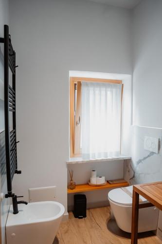 a bathroom with a sink and a toilet and a mirror at ILLASI DREAM ROOMS in Illasi