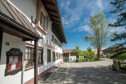 a street in a town with a building at Alpen Hotel Martin in Nesselwang