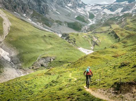 a person riding a bike on a mountain trail at Luxuse Ferienwohnung Flüe 11 in Leukerbad