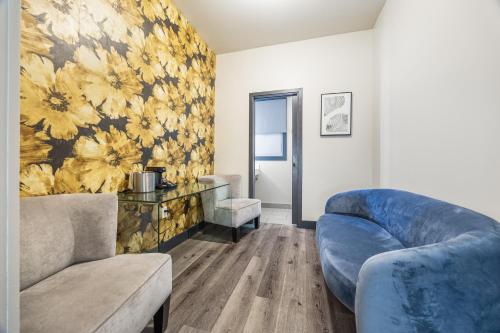 a living room with two couches and a floral wallpaper at Hotel EPIK in San Francisco