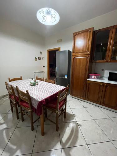 a kitchen with a table and chairs and a refrigerator at Casa San Francesco in Mondragone