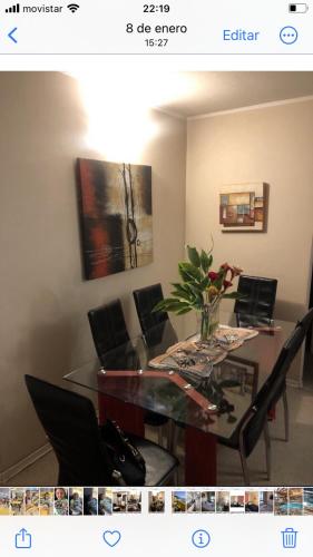 a dining room with a glass table and chairs at Departamento en Playa Bellavista, Tome in Tomé
