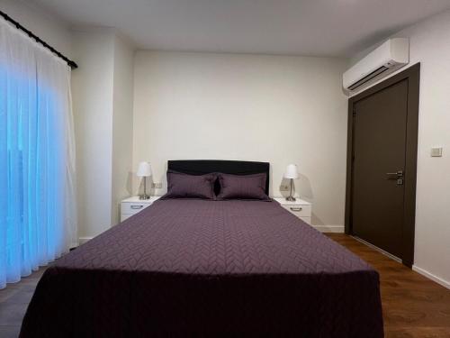 a bedroom with a bed with a purple bedspread at Su apartment side terrace no 3 in Side