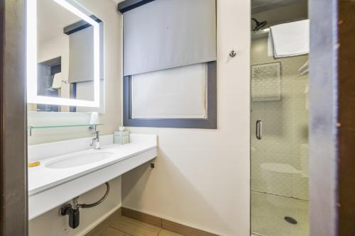 a bathroom with a sink and a glass shower at Hotel EPIK in San Francisco