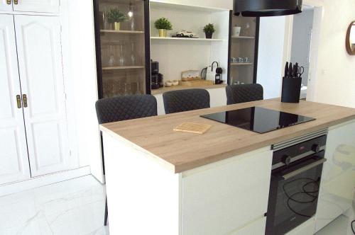 a kitchen with white cabinets and a counter top at Seafront Playa La Arena in Puerto de Santiago