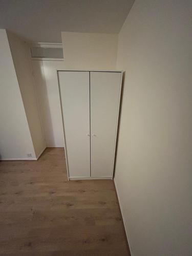 Una habitación vacía con paredes blancas y suelos de madera. en Lovely Milton Keynes Double Room, en Milton Keynes