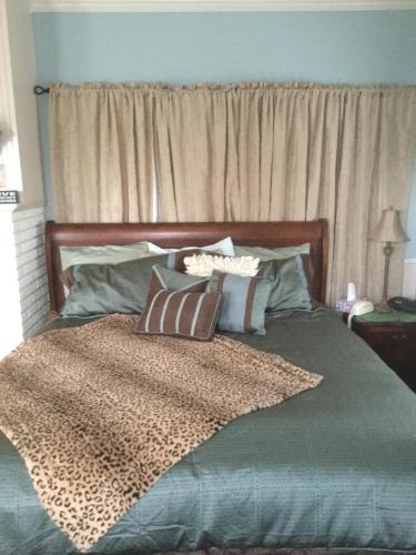 a bedroom with a large bed with pillows on it at Sunnyside Inn Bed &Breakfast in Sunnyside