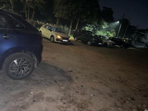 a group of cars parked in a parking lot at night at Hotel Grand Manor in Gurgaon
