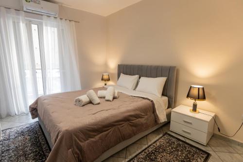 a bedroom with a bed with two stuffed animals on it at Vicky's view house in Nafpaktos