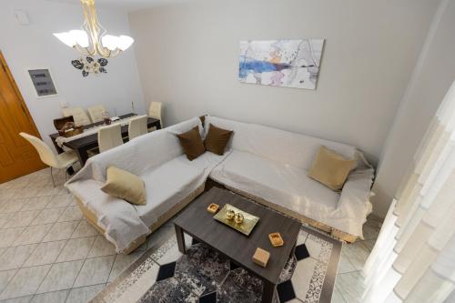 a living room with a couch and a table at Vicky's view house in Nafpaktos