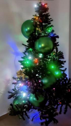 a christmas tree with green lights on it at ANK - HOME i PRESIDENT - NIK in Telcişor
