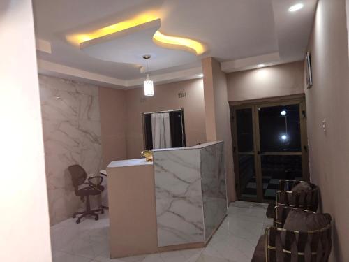 a room with a lobby with a counter and chairs at Zuba waterfall executive Lodge in Simon Mwansa Kapwepwe International Airport