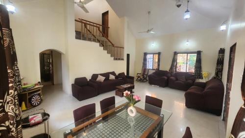 a living room with a couch and a table at kareeshmavilla in Mahabaleshwar