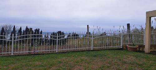 a wooden fence with a gate in a yard at Guest house Vila Luka 2 in Portorož