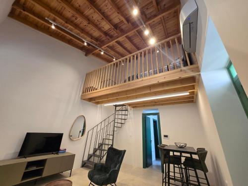 a room with a staircase and a table and chairs at Green Leaf - Old City Suite in Limassol