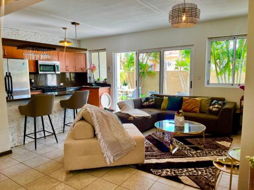 a living room with a couch and a table at Bohemian Townhouse Palm Beach Aruba in Palm-Eagle Beach