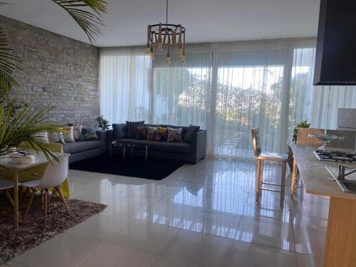 a living room with a couch and a table at Melrose beach apartment in Tamaris